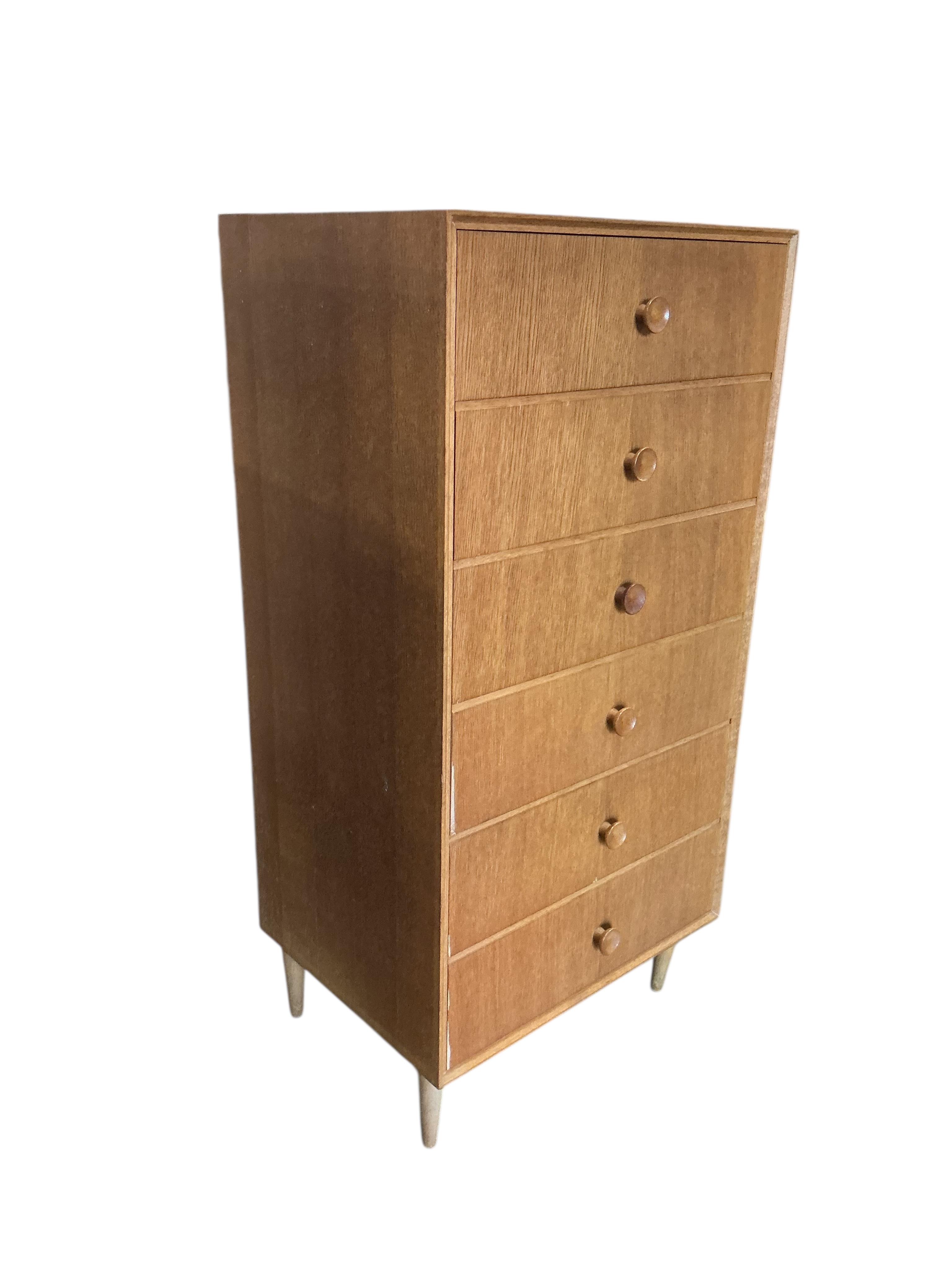 A mid century oak six drawer chest, width 61cm, depth 46cm, height 124cm